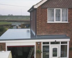 Grey GRP flat roof fitted to a rear extension