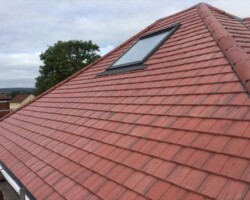 Red tiled roof with new roof window fitted