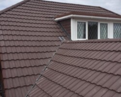 Brown tiled roof and dormer completed by Rosenberg Roofing